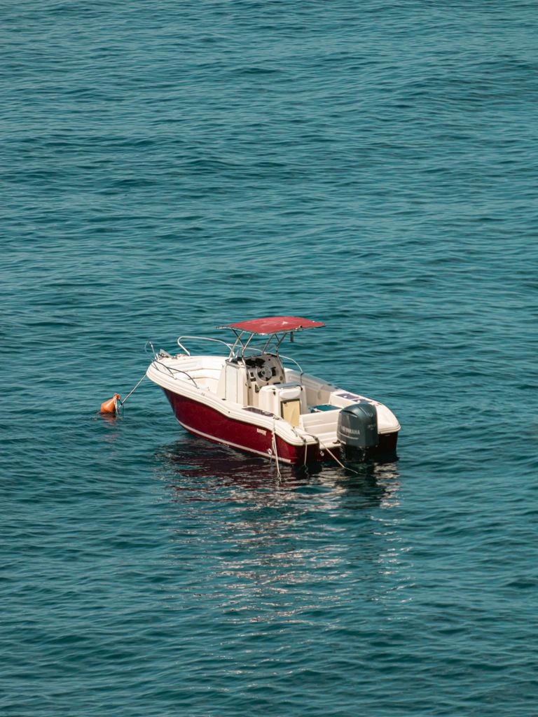 A motor yacht at anchor in a bay off Cap-Ferrat, late summer afternoon.